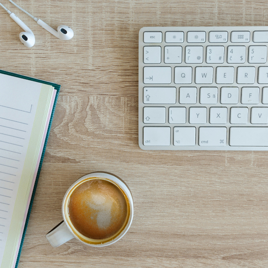 Dev Tech Solutions | displaying a coffee next to an apple keyboard