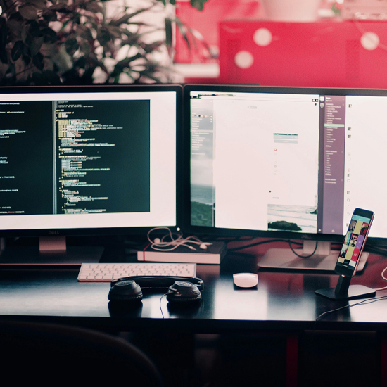 Dev Tech Solutions | showing a double monitor setup with website assets open